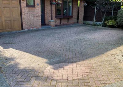 Stained brick driveway before cleaning